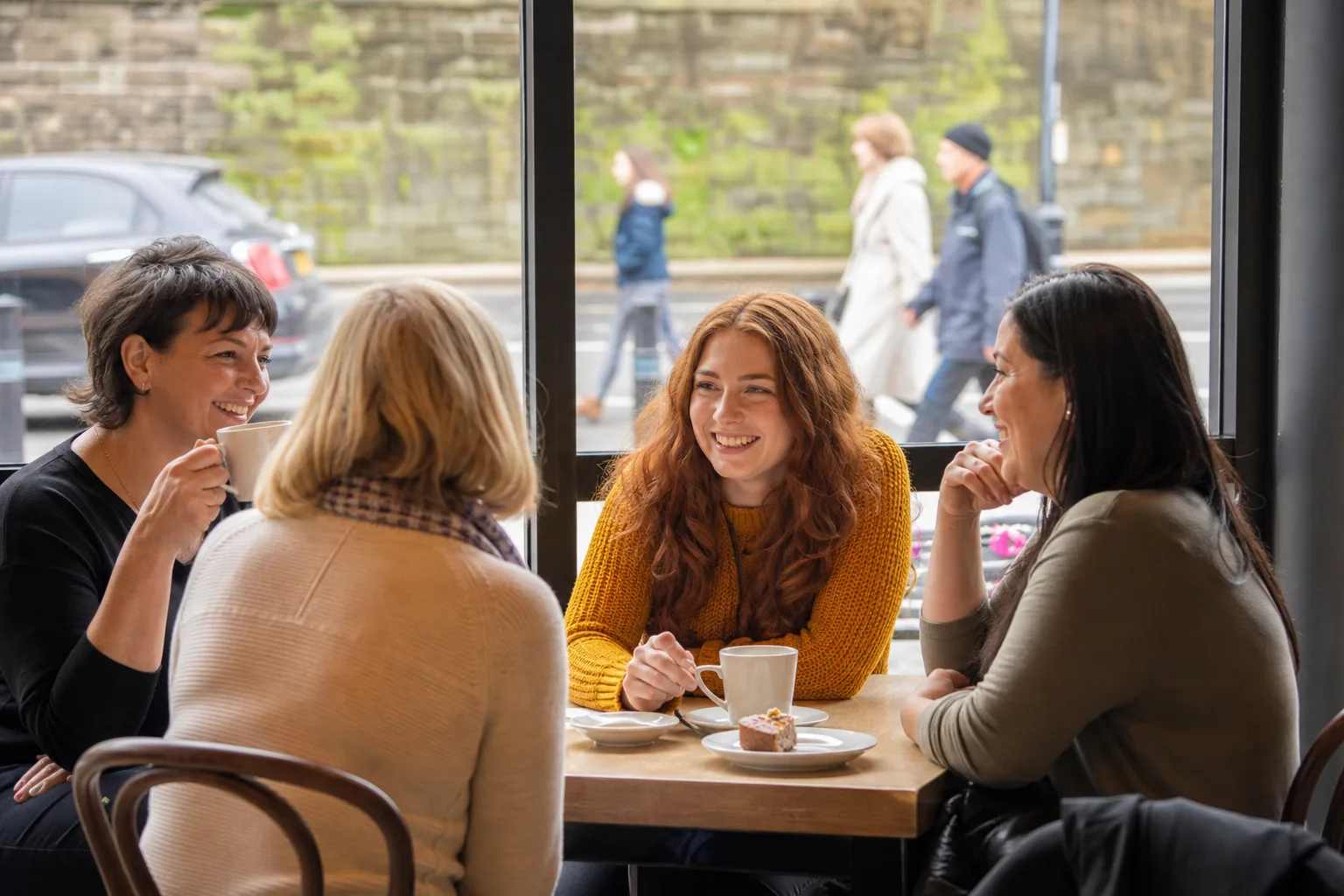 Two people talking over coffee at a relaxed Sussex café